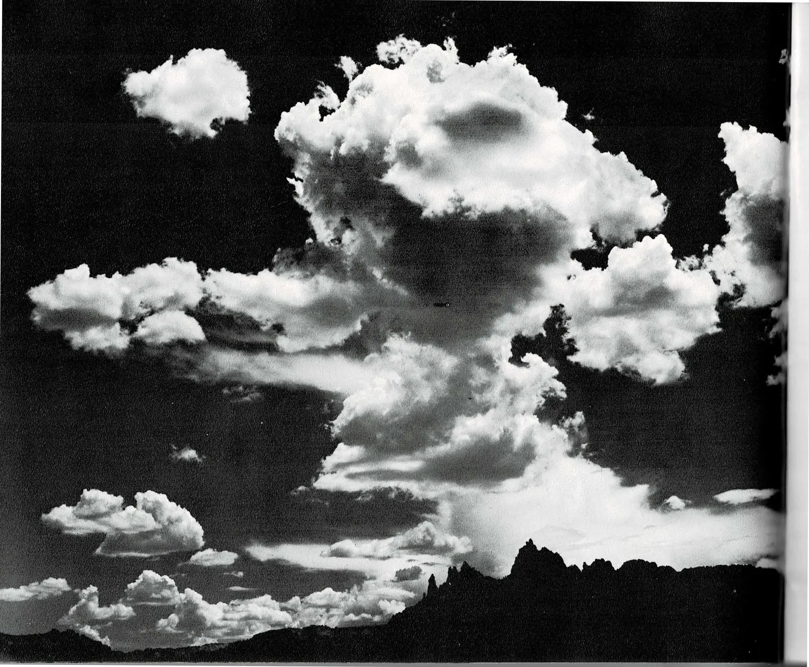 A three-panel spread: at left, a full-bleed black and white photograph of towering cumulus clouds building over the dark silhouette of Eagle Crags; in the center, a text column describing color and light in the Finger Canyons in almost musical terms; at right, a color photograph of an autumn stream in the Kolob, yellow and orange cottonwood leaves overhanging a still pool beside a large boulder.