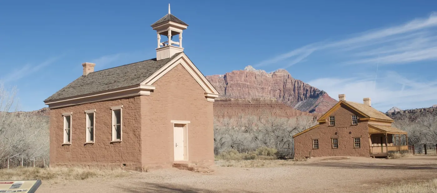 Grafton ghost town schoolhouse and farmhouse with Zion National Park mountains in background