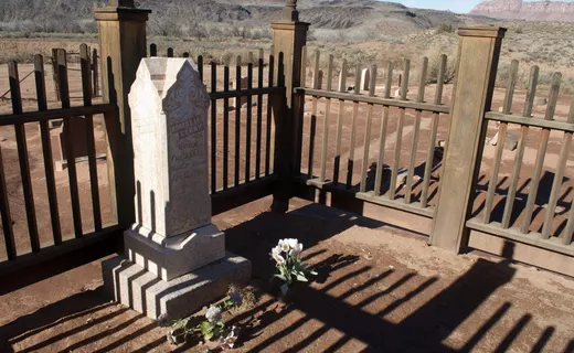 Grafton cemetery wooden fence enclosure with tall marble gravestone and red cliffs behind