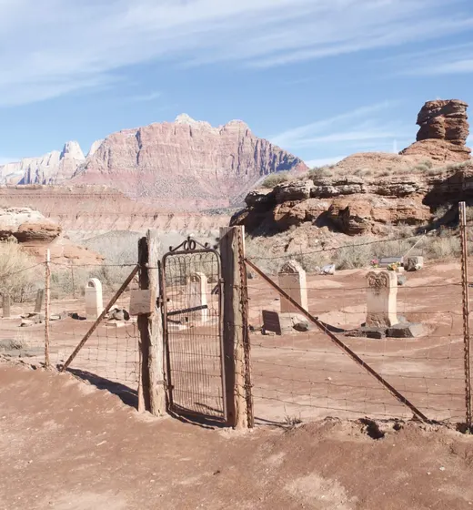 Iron gate of Grafton cemetery with Zion National Park mountains in background